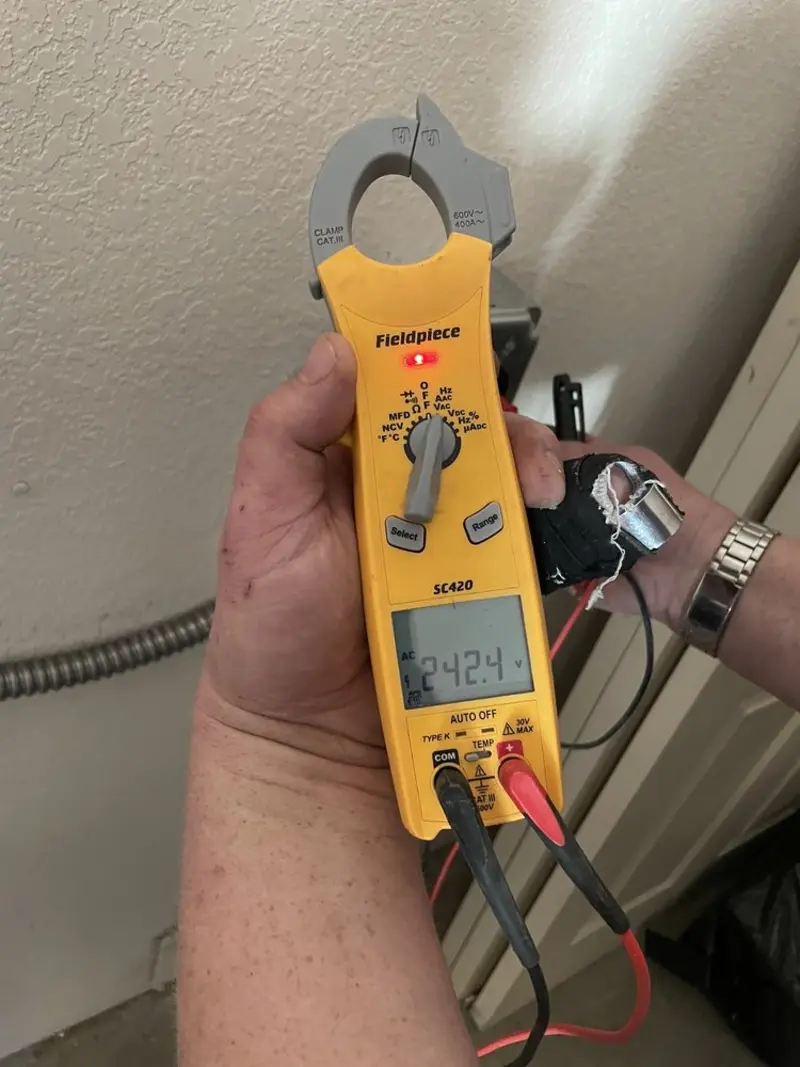 Voltage testing with clamp meter during Outlet Installation in Miami